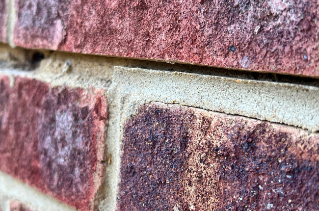 Gap in mortar caused by wall tie corrosion Cracking caused by wall tie corrosion