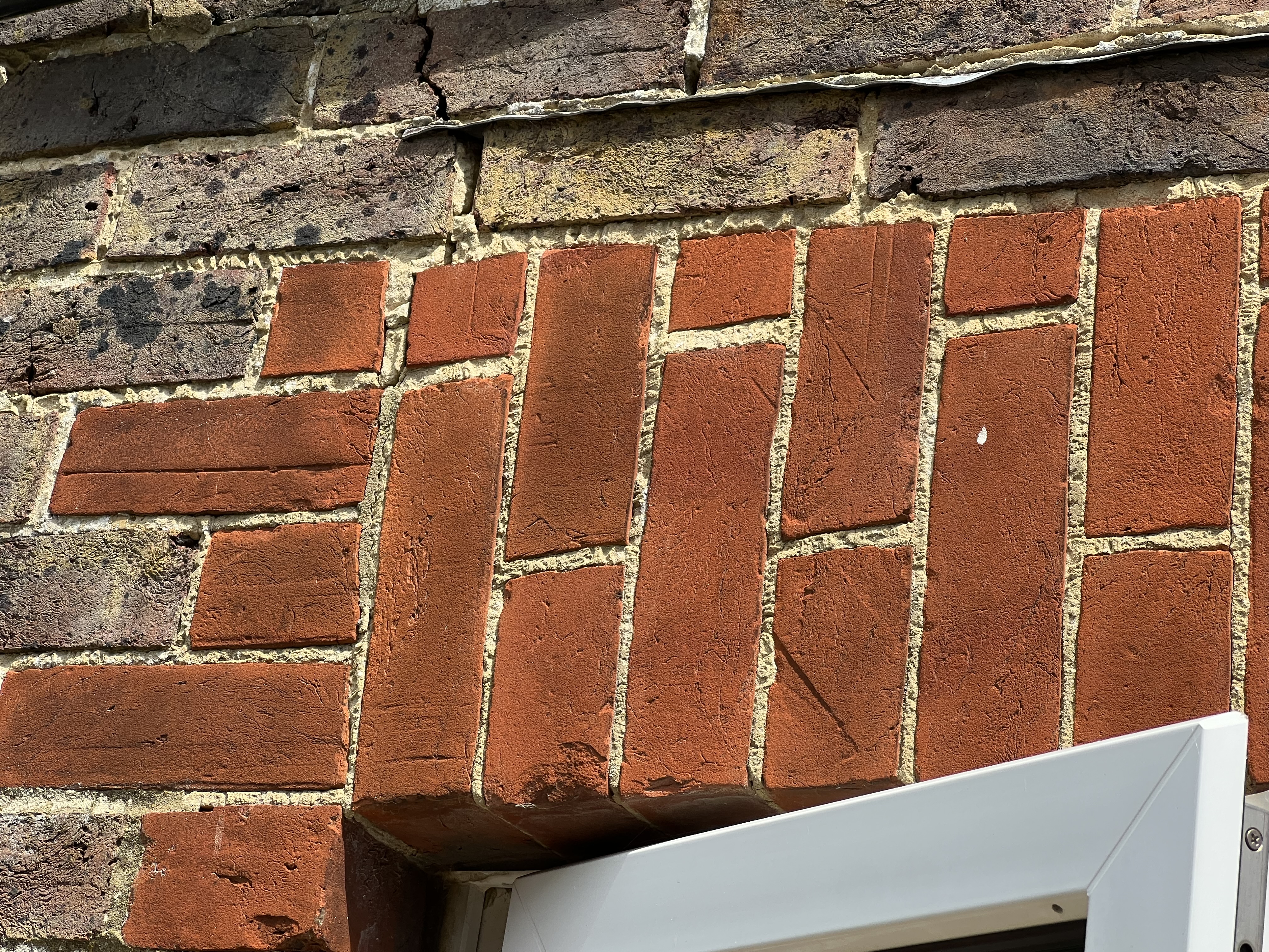 Brick arch dropped onto a window Photo showing cracking of a brick arch